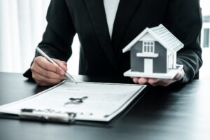 Real estate agent working sign agreement document contract for home loan insurance