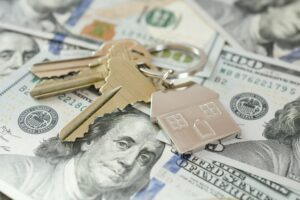 Housing Market concept - house keys on money currency, real estate, home loan, equity buy sell